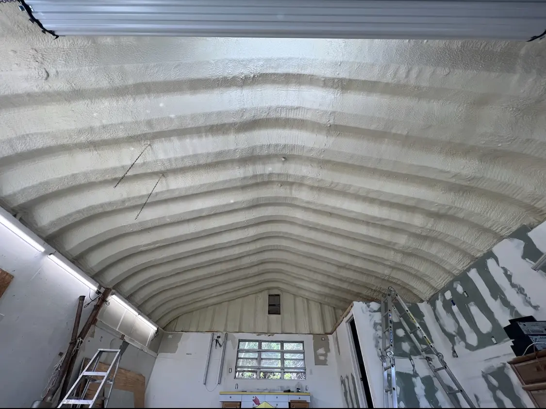 Spray polyurethane foam applied to the underside of a metal roof deck in Paris